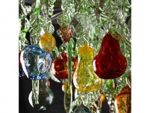 Glass chandelier with green leaves, blown fruit and berries